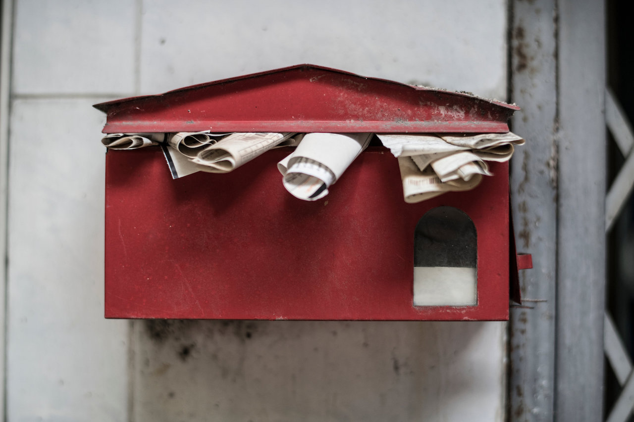 An overfull old post box